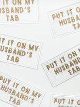 Load image into Gallery viewer, Put It On My Husband's Tab White Iron-On Patch Happy Hour