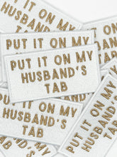 Load image into Gallery viewer, Put It On My Husband's Tab White Iron-On Patch Happy Hour